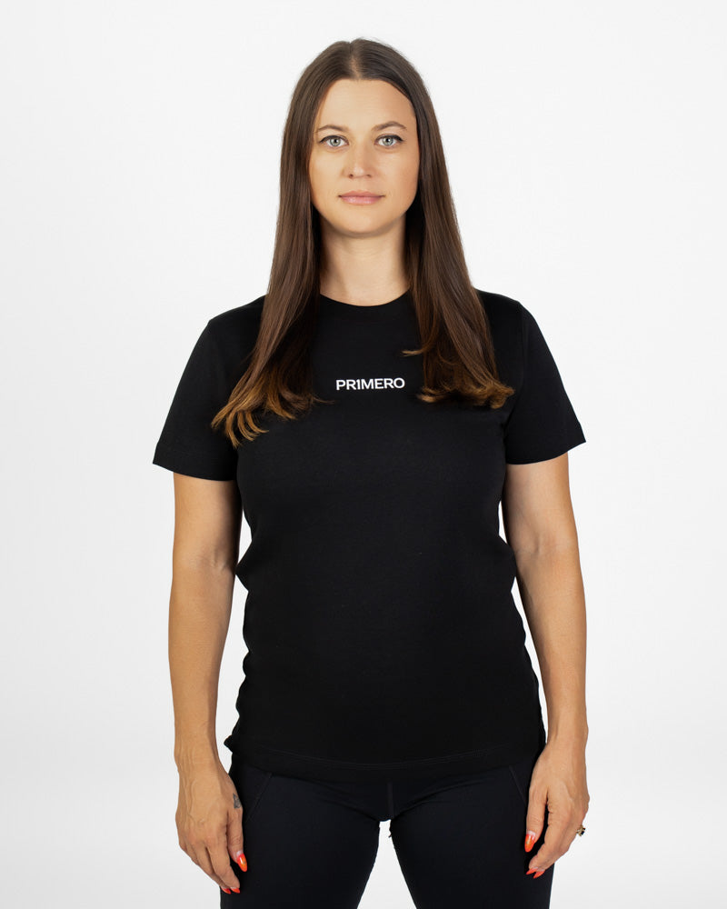 Woman wearing a black t-shirt with 'PRIMERO' logo on a white background